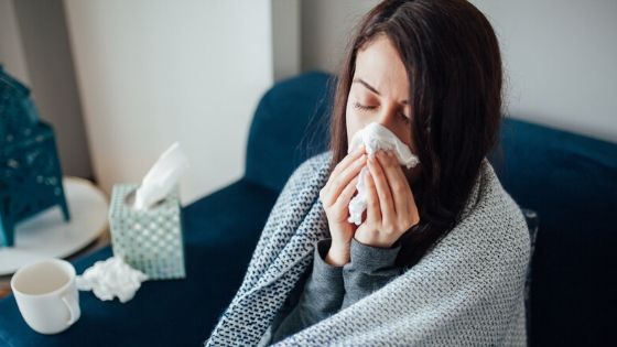 Sick young woman struggling with a cold.