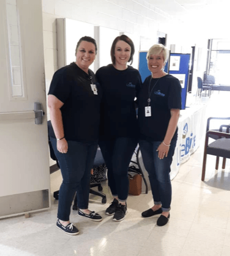 Three female LifeBrite employees pose for photo during community activity.