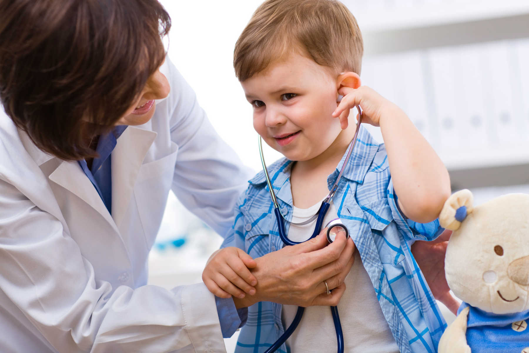 A child receiving medical care from a physician.